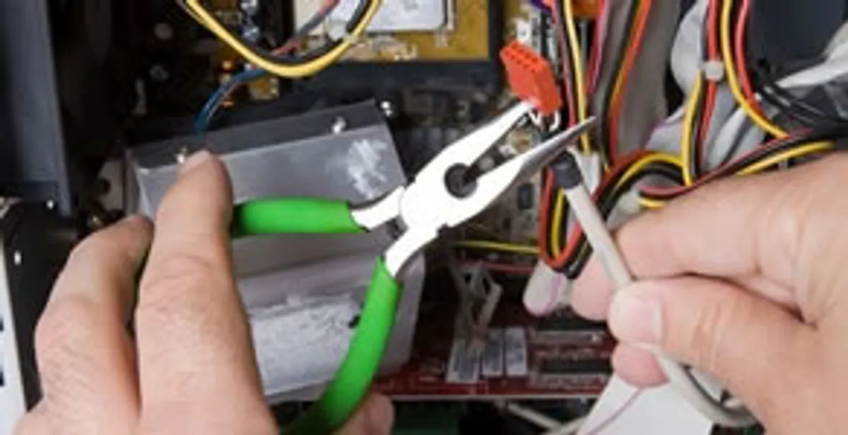 Licensed electrical contractor performing electrical repair with tools in North Houston, TX